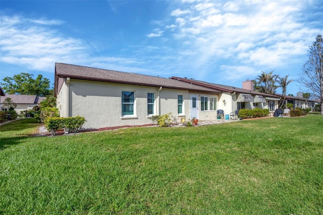 rear view of property featuring a yard