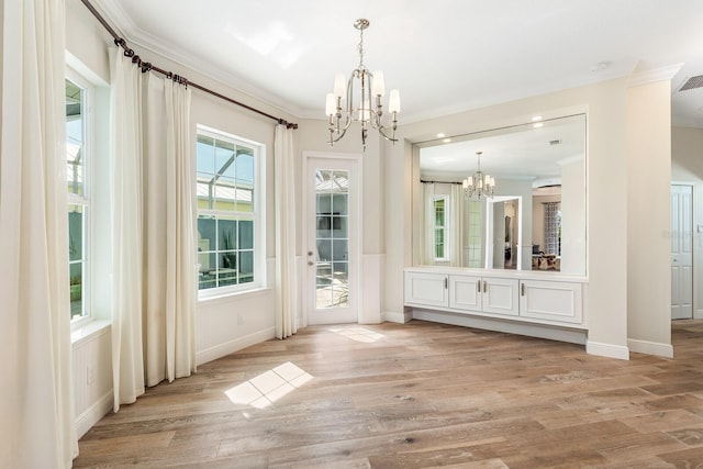 interior space featuring visible vents, baseboards, light wood-style flooring, ornamental molding, and a chandelier