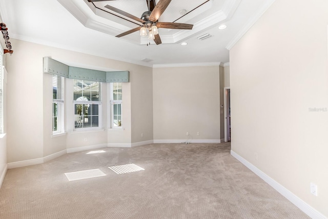 unfurnished room with recessed lighting, visible vents, baseboards, ornamental molding, and a tray ceiling