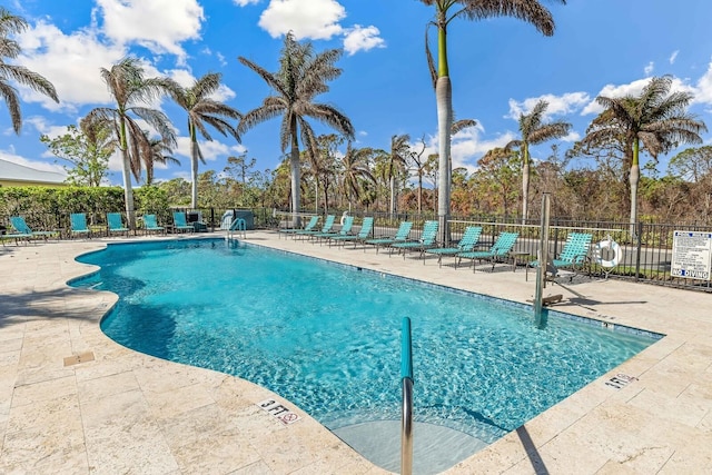 community pool featuring a patio and fence