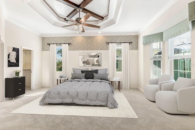 bedroom featuring a wainscoted wall, ceiling fan, light colored carpet, and crown molding