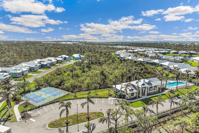 drone / aerial view featuring a forest view and a residential view