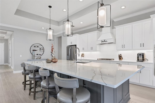 kitchen featuring white cabinetry, a large island, pendant lighting, and appliances with stainless steel finishes