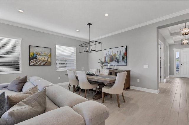 dining area with light wood-type flooring and ornamental molding