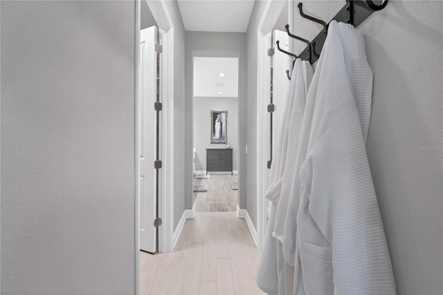 hallway with light hardwood / wood-style flooring