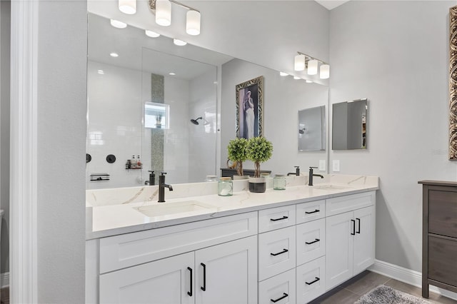 bathroom featuring tile patterned floors, vanity, and tiled shower