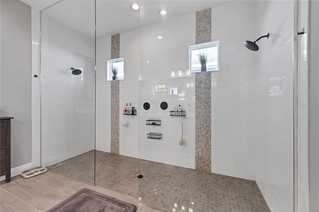 bathroom with tile patterned flooring and tiled shower