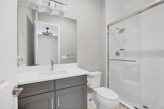 bathroom featuring vanity, toilet, and walk in shower