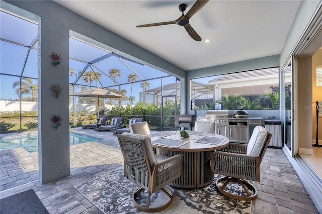 view of patio with area for grilling, ceiling fan, and a lanai