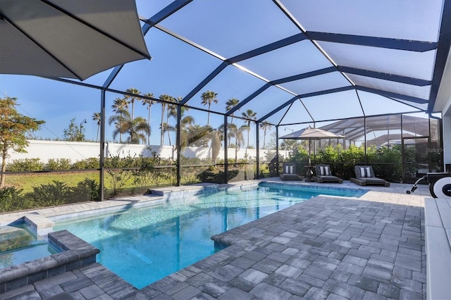 view of swimming pool featuring a lanai, a patio area, and an in ground hot tub