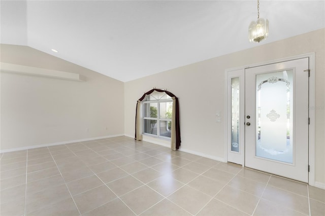 tiled entrance foyer featuring vaulted ceiling