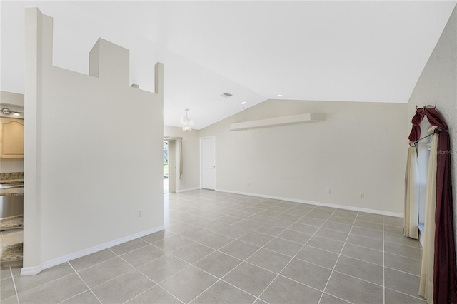 unfurnished living room with lofted ceiling and light tile patterned flooring