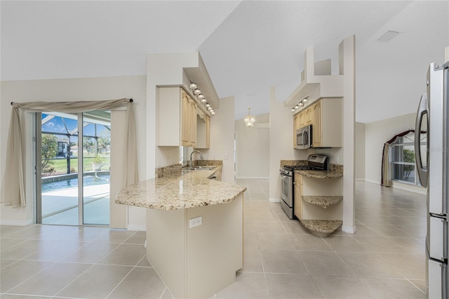 kitchen featuring light tile patterned floors, kitchen peninsula, sink, and appliances with stainless steel finishes