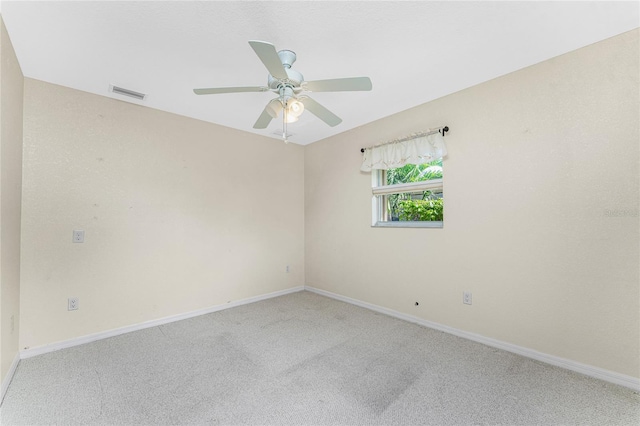 carpeted empty room featuring ceiling fan