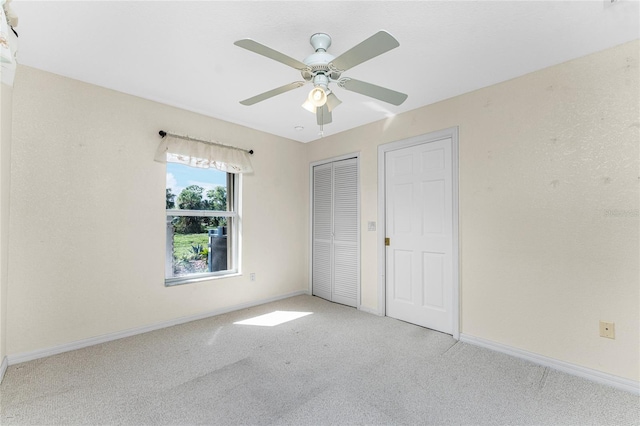 unfurnished bedroom with light carpet and ceiling fan