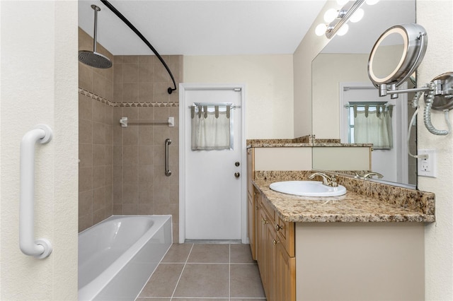 bathroom with vanity, tile patterned floors, and tiled shower / bath