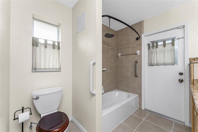 full bathroom featuring tile patterned floors, vanity, tiled shower / bath combo, a textured ceiling, and toilet