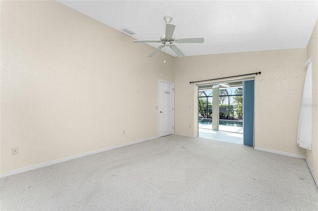 carpeted spare room with ceiling fan and lofted ceiling