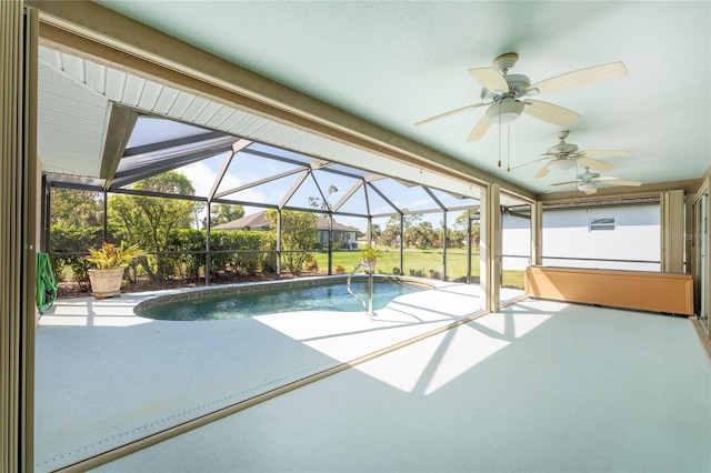 view of pool featuring a lanai, a patio area, and ceiling fan