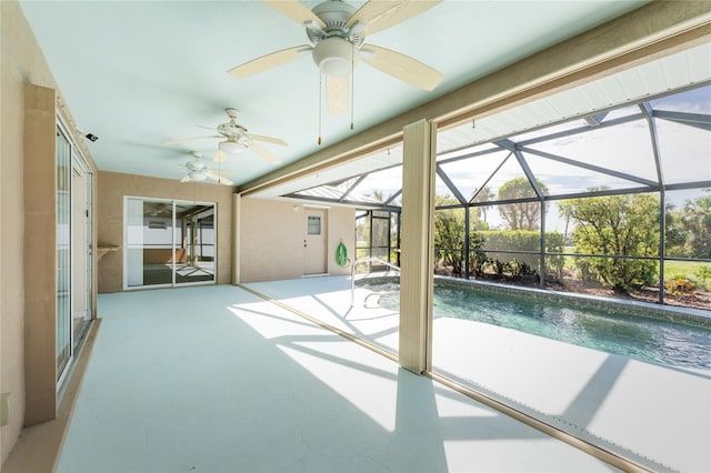 view of swimming pool with a patio, ceiling fan, and a lanai