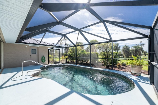 view of swimming pool featuring a lanai and a patio area