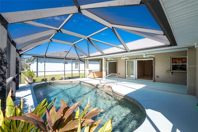 view of swimming pool featuring ceiling fan, a patio, and glass enclosure