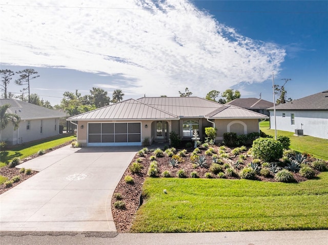 ranch-style home featuring a front lawn and a garage