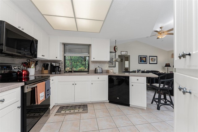 kitchen featuring appliances with stainless steel finishes, tasteful backsplash, ceiling fan, white cabinets, and lofted ceiling