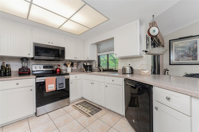 kitchen featuring white cabinets, light tile patterned floors, stainless steel appliances, and tasteful backsplash