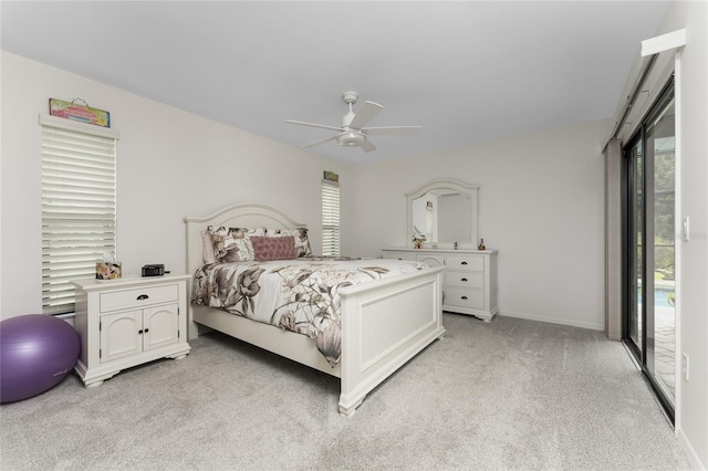 bedroom featuring access to exterior, light carpet, ceiling fan, and multiple windows