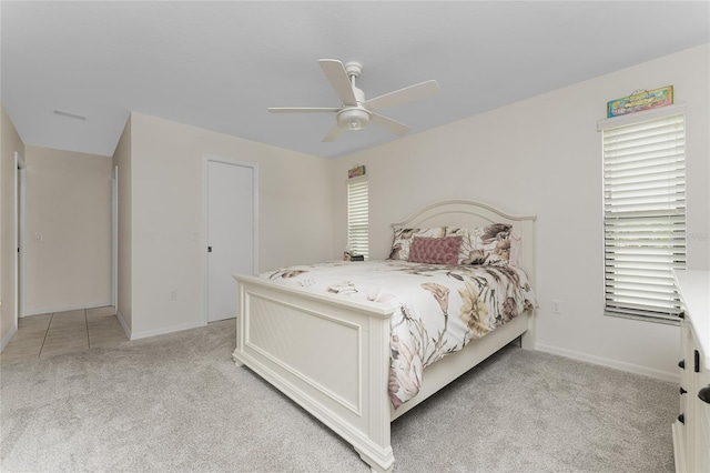 bedroom featuring ceiling fan and light colored carpet