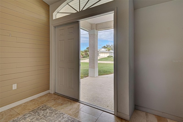 entrance foyer featuring wood walls