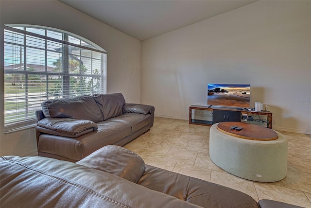 tiled living room featuring vaulted ceiling