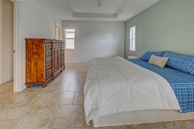 tiled bedroom with a tray ceiling