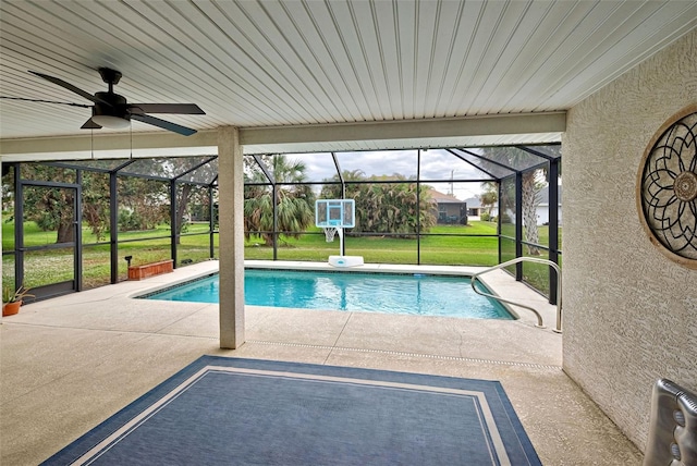 view of pool featuring a yard, a patio, ceiling fan, and a lanai