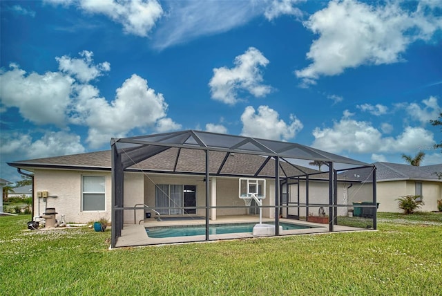 back of property featuring a lawn, glass enclosure, and a patio area