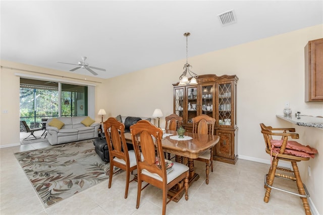 dining space with ceiling fan and light tile patterned floors