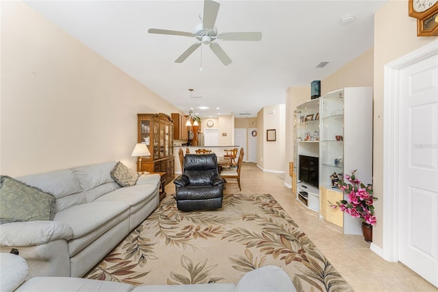 living room with ceiling fan and light tile patterned flooring