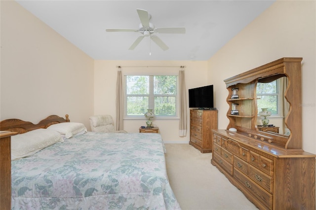 carpeted bedroom featuring ceiling fan and multiple windows