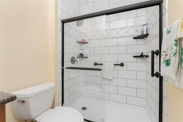 bathroom with an enclosed shower and toilet