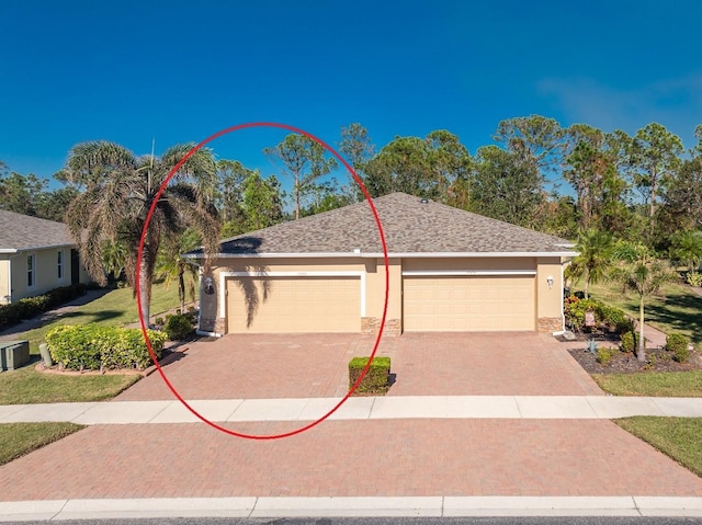 13488 Abercrombie Dr, Englewood, FL 34223 - ranch-style house with stucco siding, a garage, decorative driveway, and roof with shingles