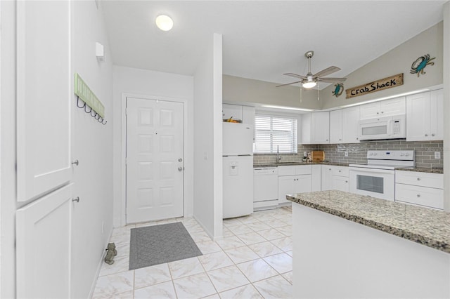 kitchen featuring white cabinetry, ceiling fan, light stone countertops, lofted ceiling, and white appliances