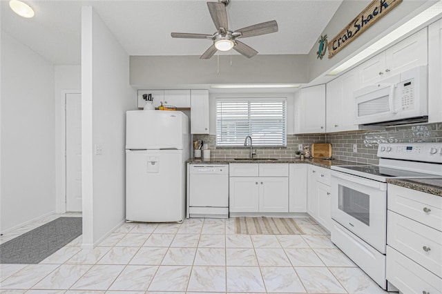 kitchen with sink, dark stone counters, a textured ceiling, white appliances, and white cabinets