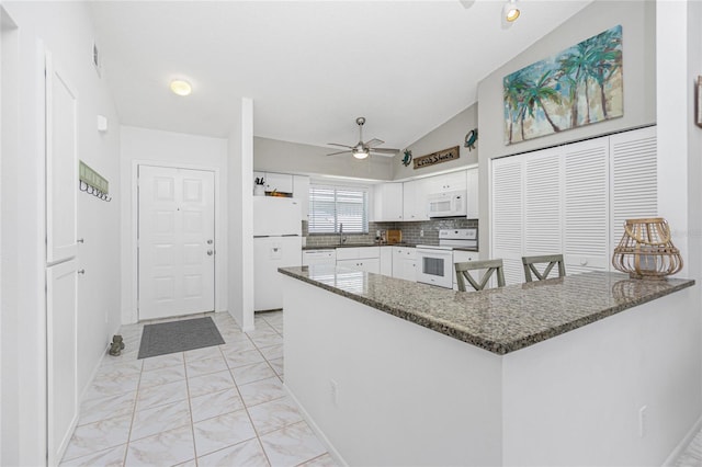 kitchen featuring kitchen peninsula, white appliances, ceiling fan, white cabinetry, and lofted ceiling