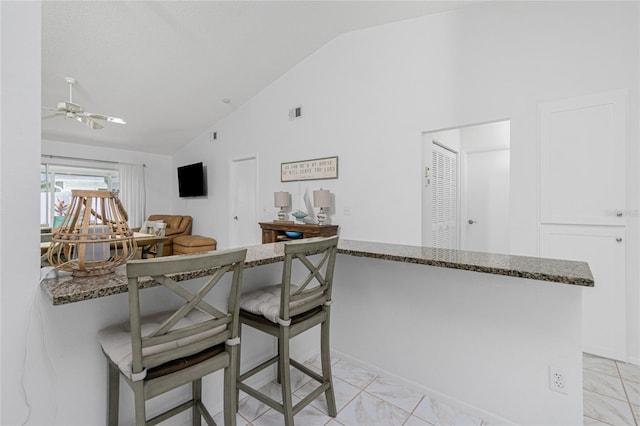 dining room with vaulted ceiling and ceiling fan