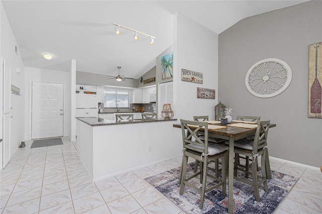 dining room featuring ceiling fan and vaulted ceiling