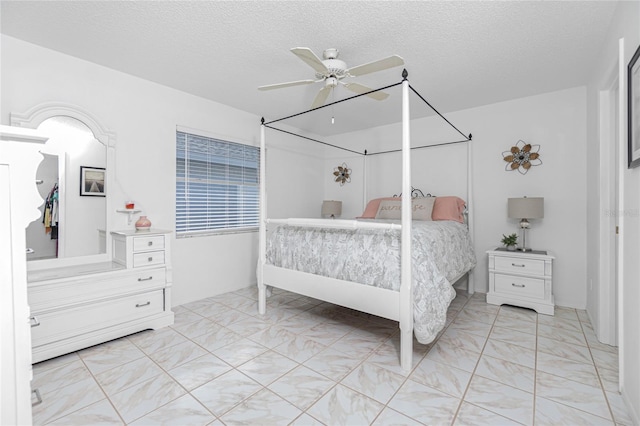 bedroom featuring a textured ceiling and ceiling fan