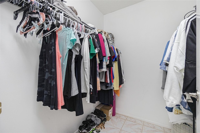 spacious closet with light tile patterned floors