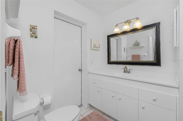 bathroom with tile patterned floors, vanity, and toilet