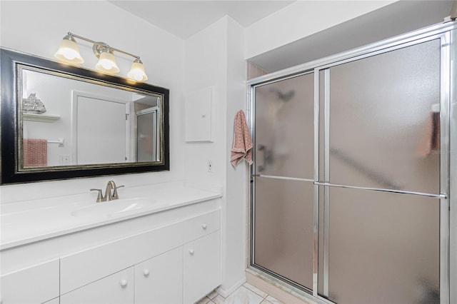 bathroom featuring tile patterned flooring, vanity, and a shower with shower door